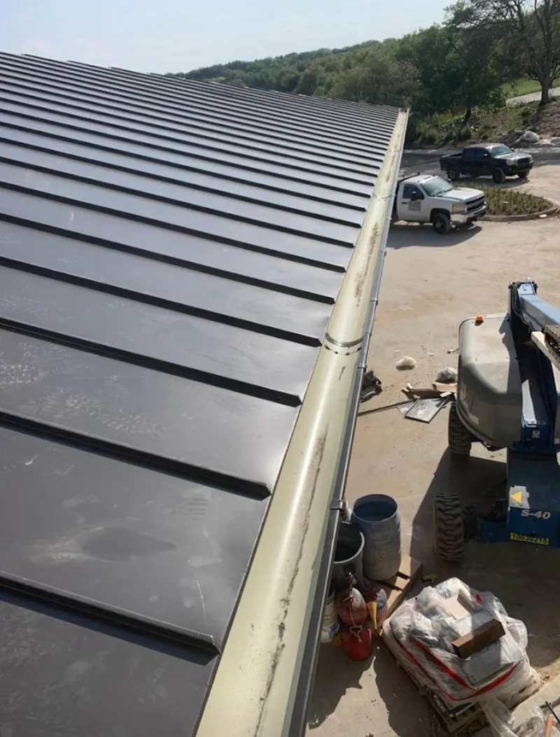 Standing seam panel and gutter detail on a metal roofing jobsite in West Covina